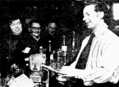 Peter Keenan pulling a pint in his bar. 1976